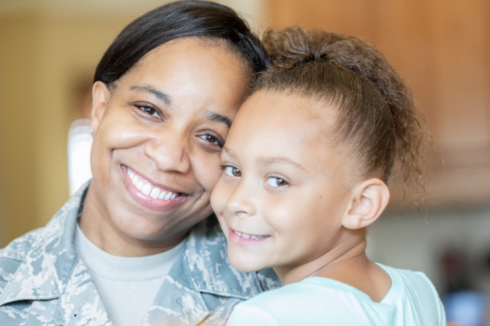 Veteran Mom with Daughter smiling for photo 